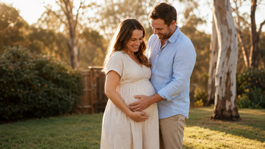 Pregnant Australian couple at golden hour in eucalyptus backyard — lifestyle gender reveal photo