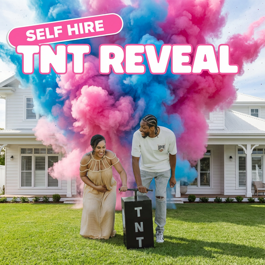 Couple outside house using TNT Gender Reveal kit with large pink and blue smoke explosion behind them on grass lawn