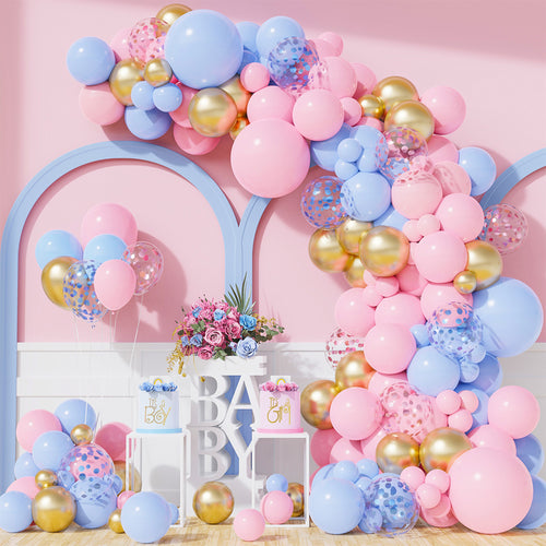 Mega Reveal Gender Party Bundle featuring an elegant balloon arch garland in pink, blue, and gold, decoratively arranged with confetti-filled balloons over white display blocks spelling 'BABY', complemented by floral arrangements and curved architectural elements against a pink backdrop