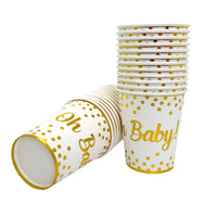 White paper cups with gold Oh Baby text and polka dots, stacked for gender reveal or baby shower celebrations