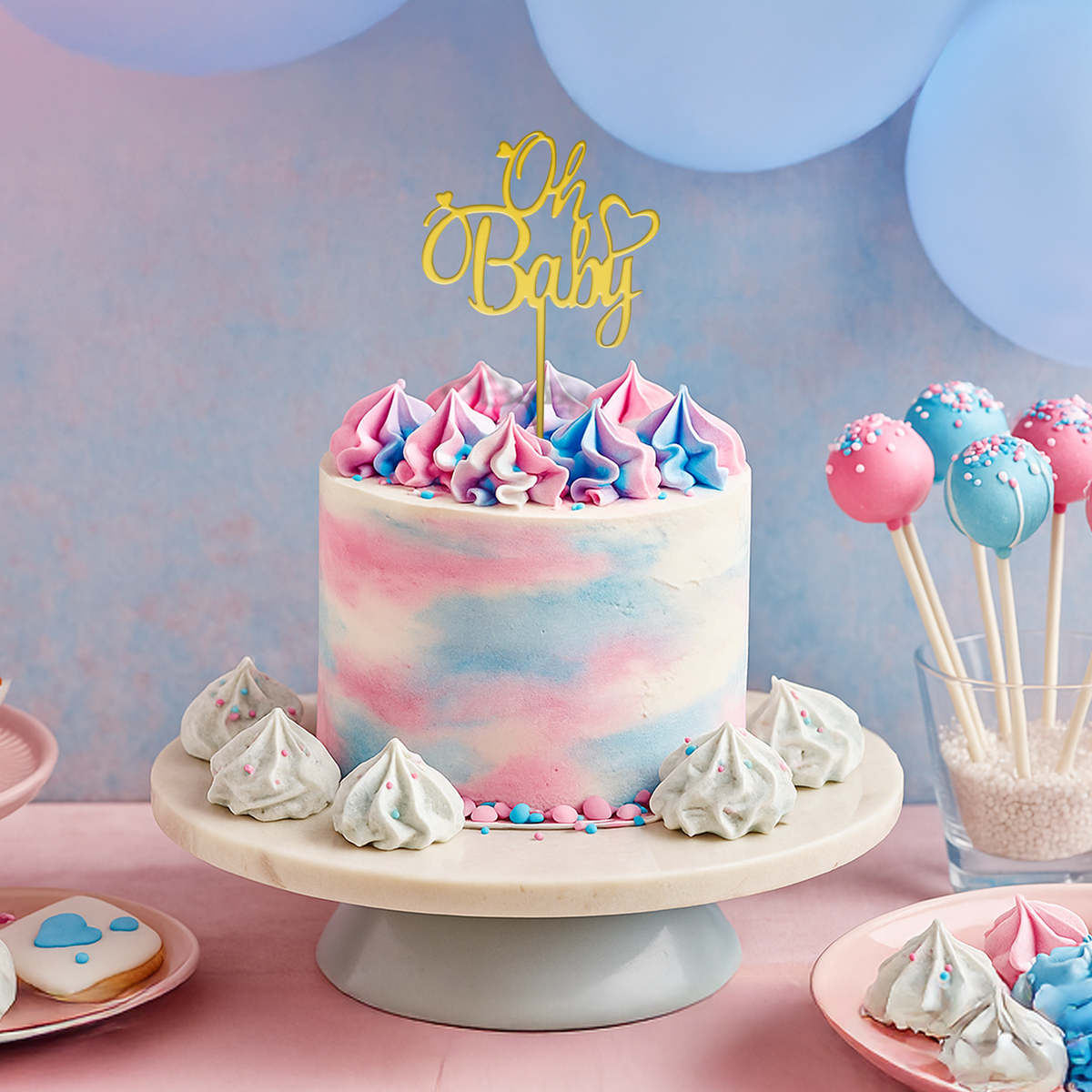 Oh Baby" Acrylic Cake Topper Gold on pastel pink and blue baby shower cake with matching treats on cake stand